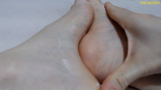 Moisturizing her little feet and getting them ready for a footjob